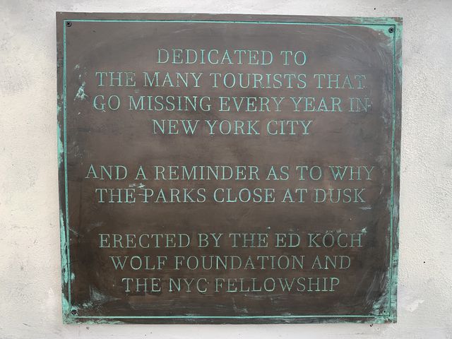 This is a photo of a plaque on a hoax sculpture to the NYC tourists allegedly taken by wolves.